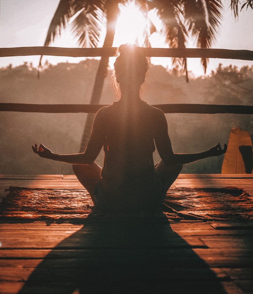 Meditation for Nurses 1 woman doing yoga meditation on brown parquet flooring